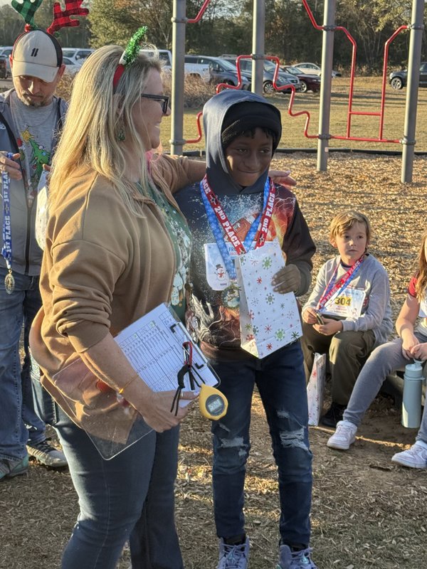Runners with medals at end of race.