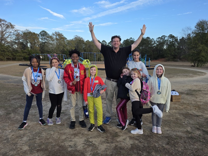 Runners with medals at end of race.