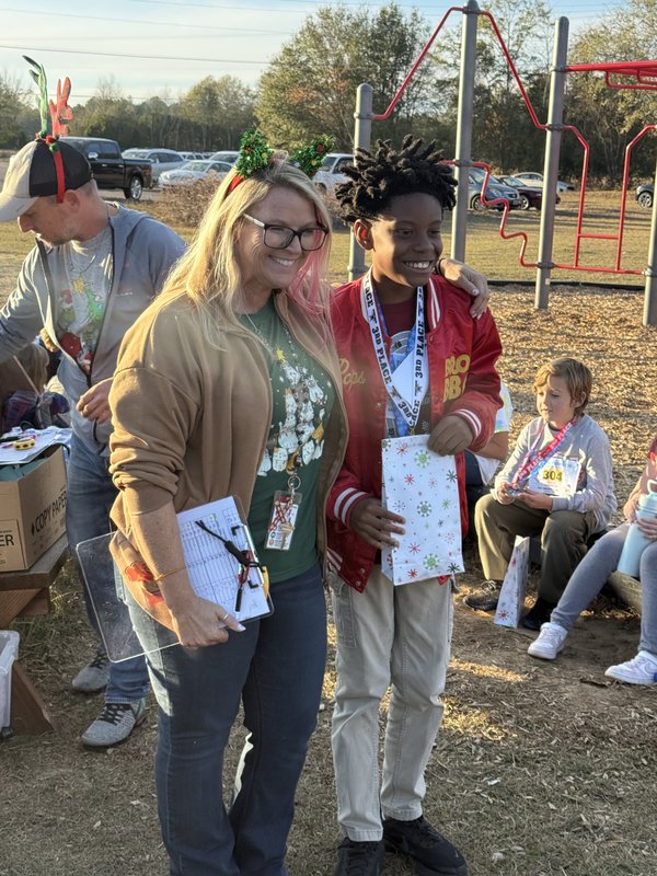 Runners with medals at end of race.