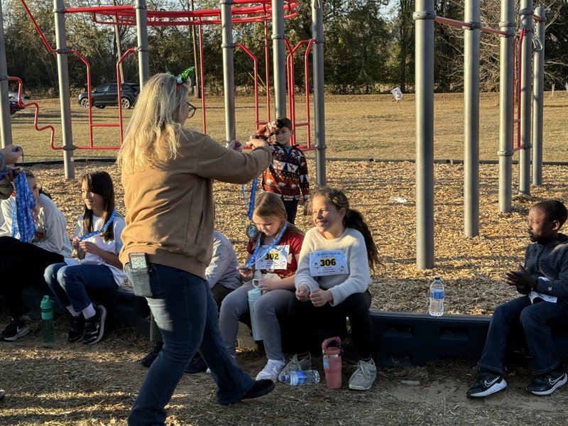 Runners with medals at end of race.