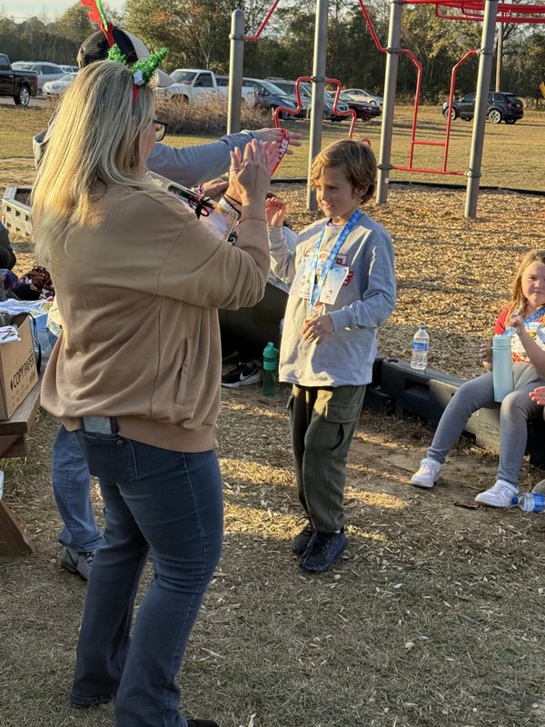Runners with medals at end of race.