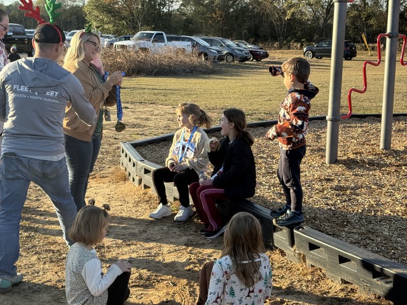 Runners with medals at end of race.
