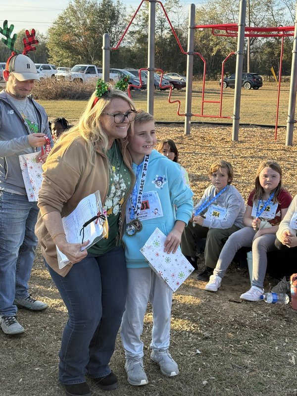 Runners with medals at end of race.