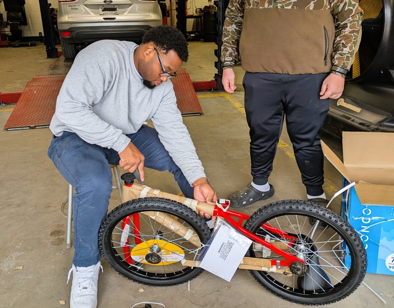students assembling a bicycle.