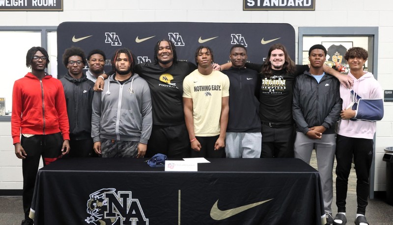 Team of football players with NAHS display.