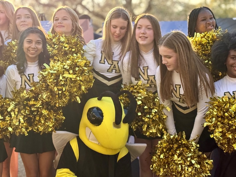 NAMS Cheerleaders and mascot pose for a group photo.