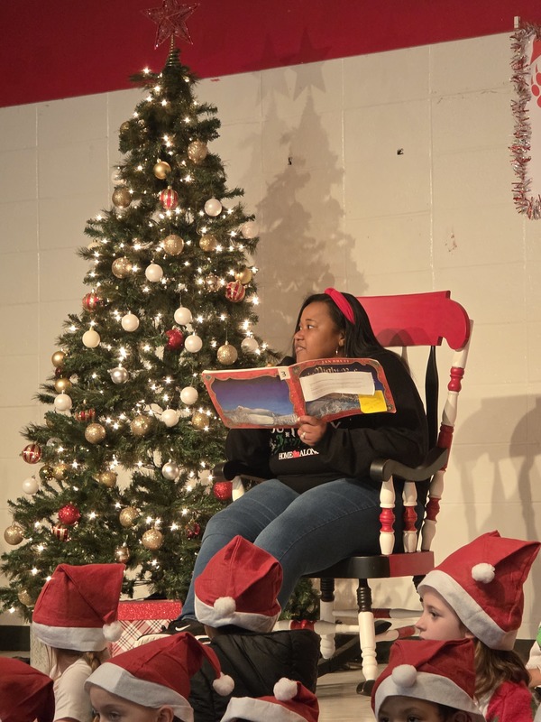 Staff reading book in a rocking chair.