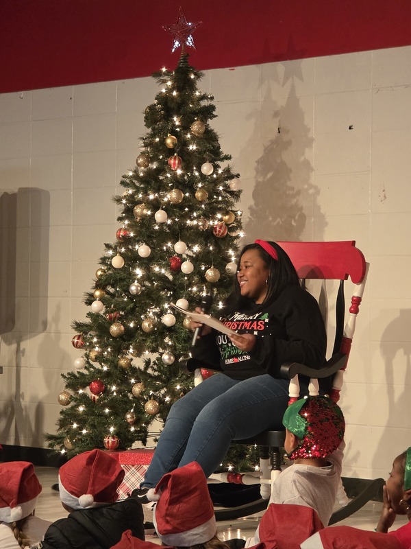 Staff reading a book in a rocking chair.