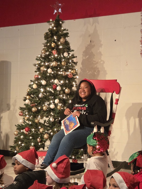 Staff reading a book in a rocking chair.