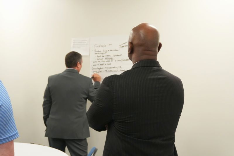 Dr. Murphy observing topics being written on board during discussion.