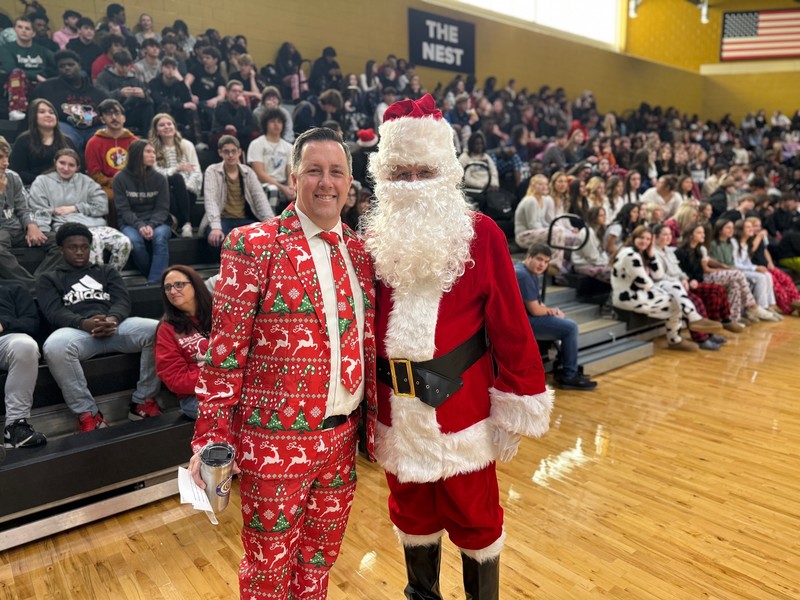 Principal, Casey Rogers and Santa posing for a photo. 
