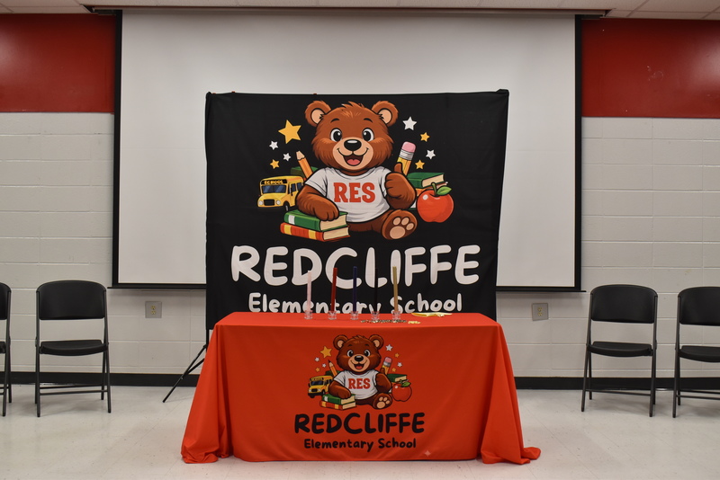 Table with candles and RES bear backdrop.