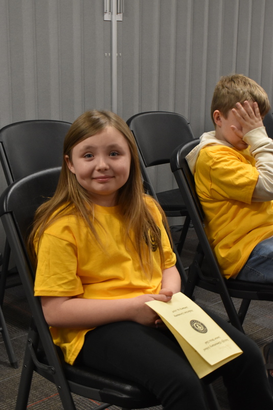 Students smiling in audience.