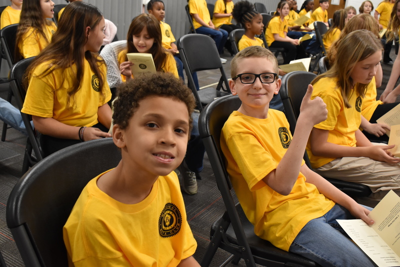 Students smiling in audience.