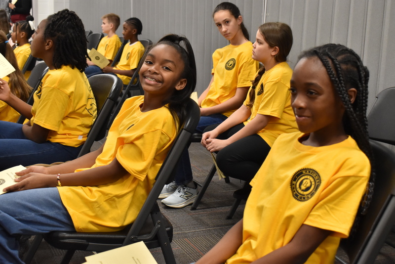 Students smiling in audience.