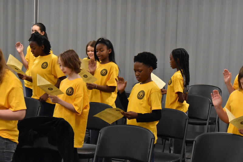 Students reading from flyers.