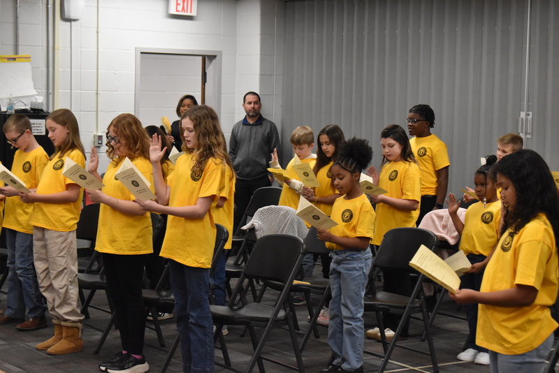 Students reading from flyers.