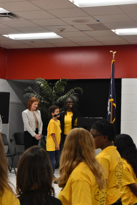 Student and staff on stage.