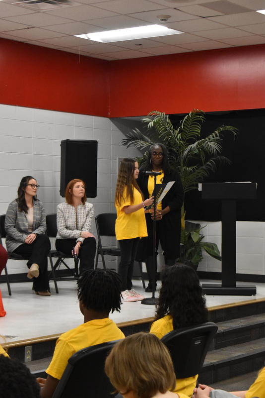 Student speaking into microphone.