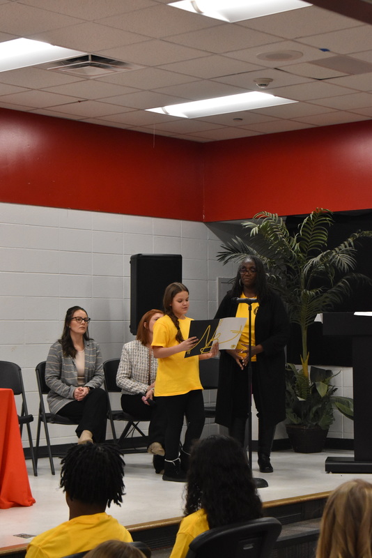 Student speaking into microphone.