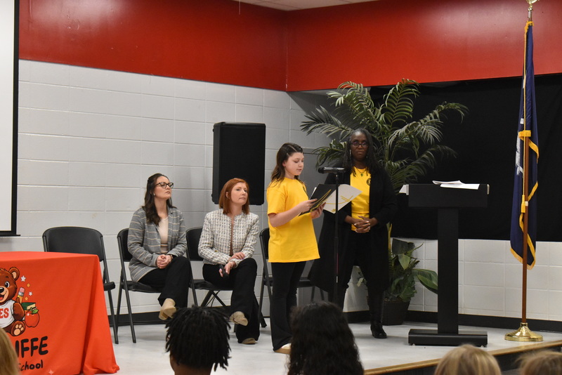 Student speaking into microphone.