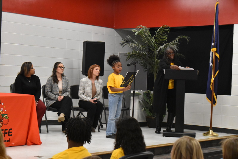 Student speaking into microphone.