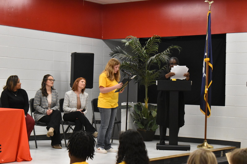 Student speaking into microphone.