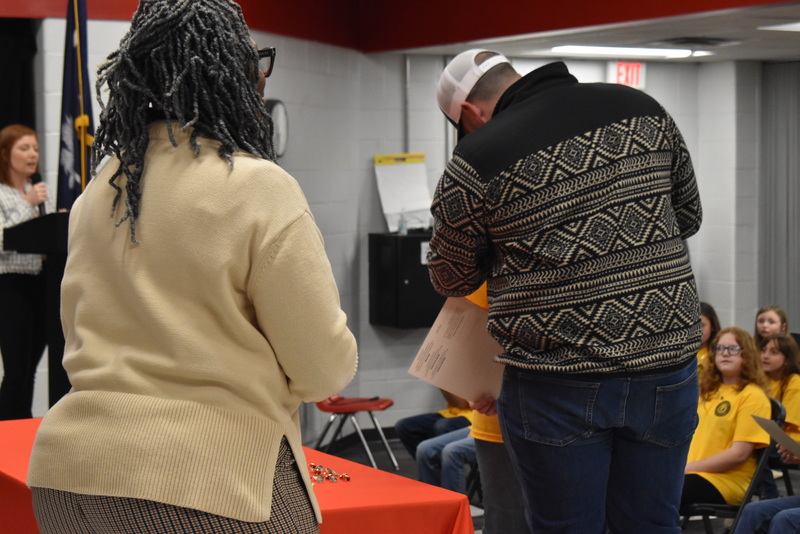 Student being pinned by guardian.