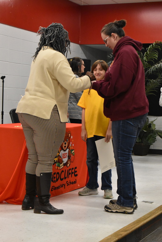 Student being pinned by family.