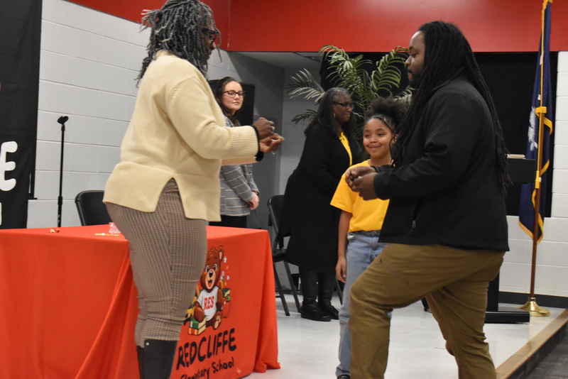 Student being pinned by family.