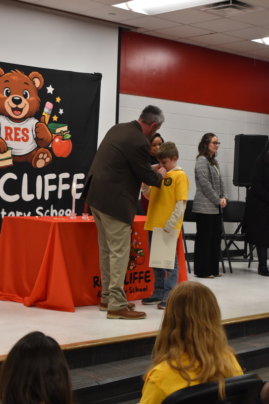 Student being pinned by family.
