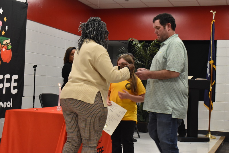 Student being pinned by family.