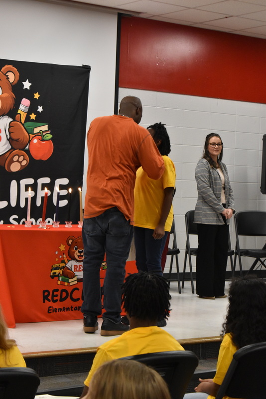 Student being pinned by family.