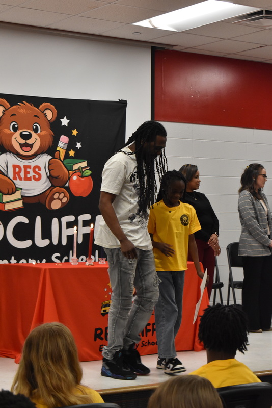 Student being pinned by family.