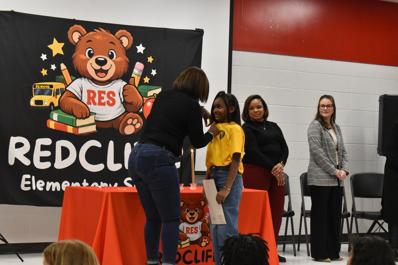 Student being pinned by family.