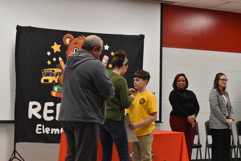 Student being pinned by family.