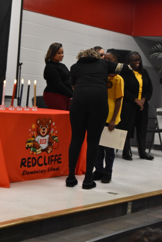 Student being pinned by family.