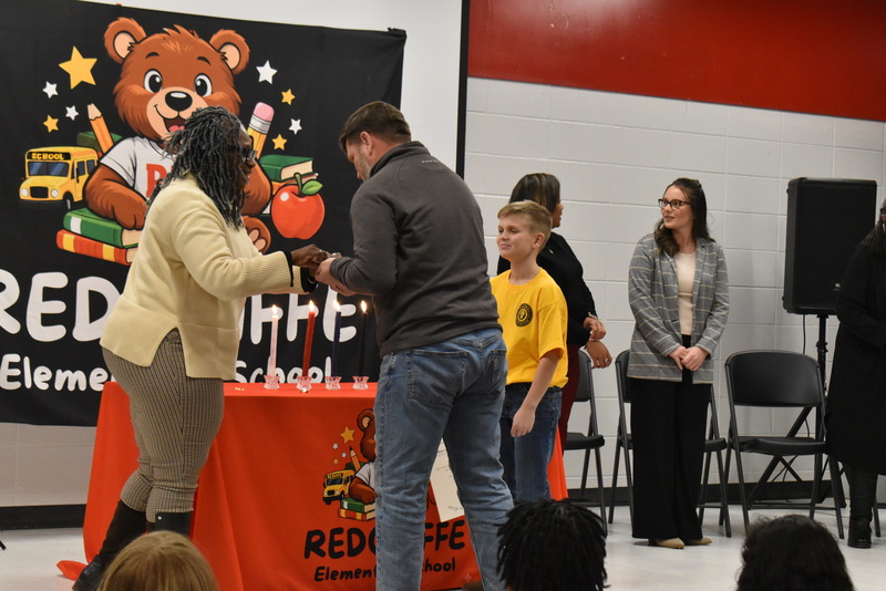 Student being pinned by family.