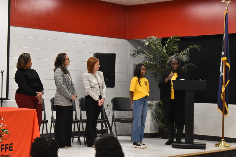 Student standing on stage.