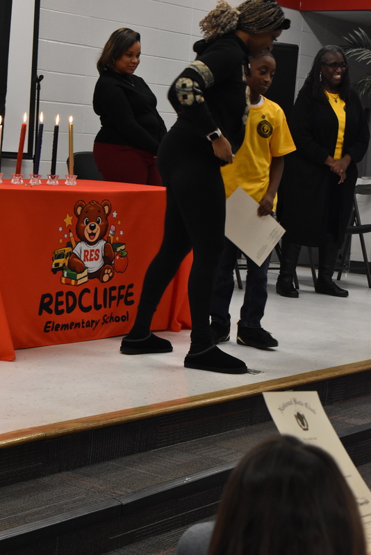 Student being pinned by family.