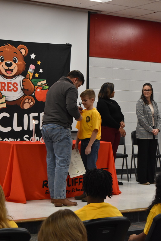 Student being pinned by family.