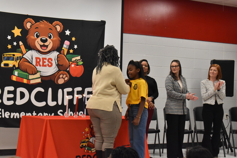 Student being pinned by teacher.