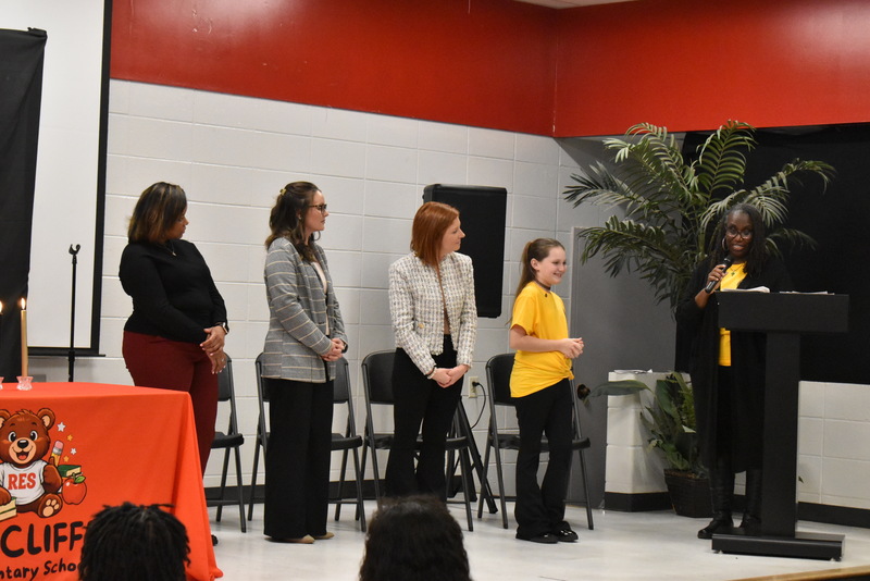 Student standing on stage.