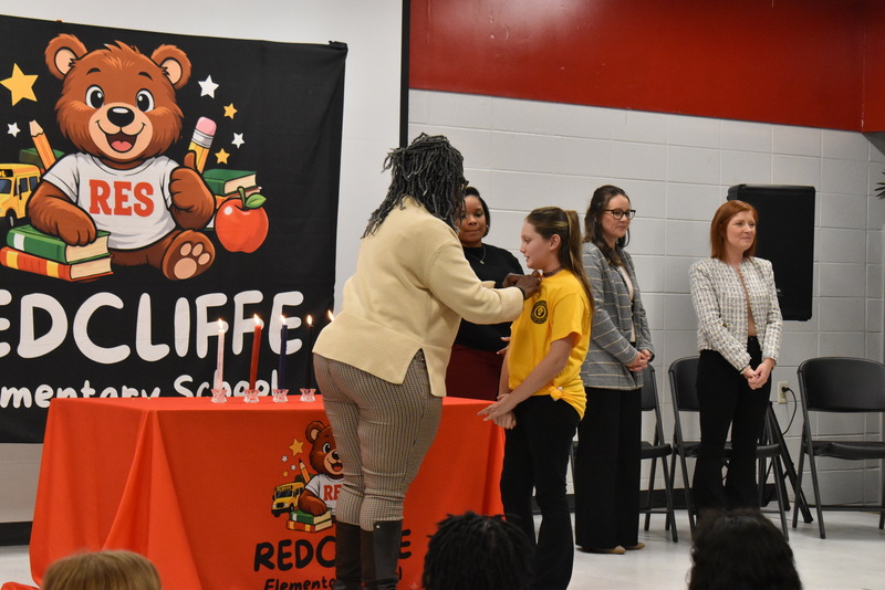 Student being pinned by teacher.