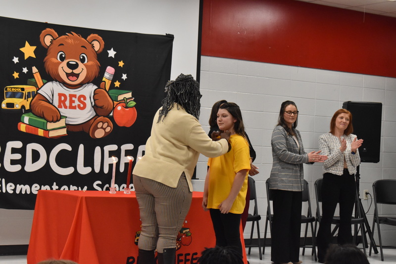 Student being pinned by teacher.