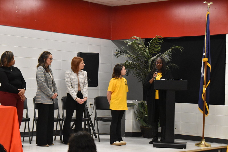 Student standing on stage.