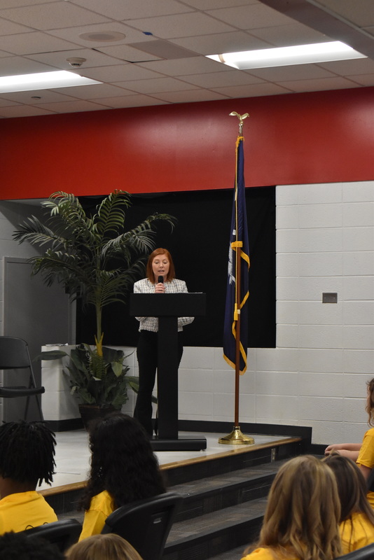 Staff speaking into microphone.