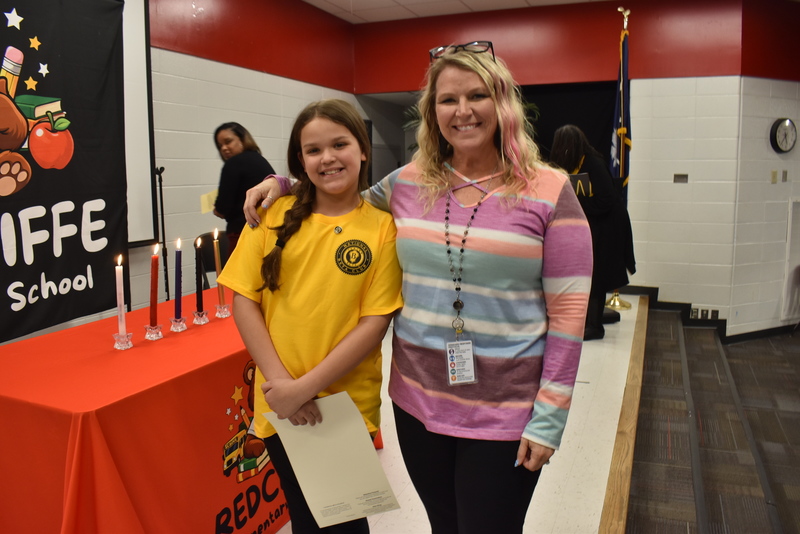 Student with family on stage.