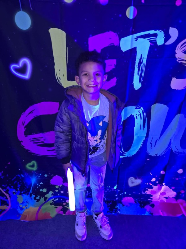 Students in glow party photo booth.