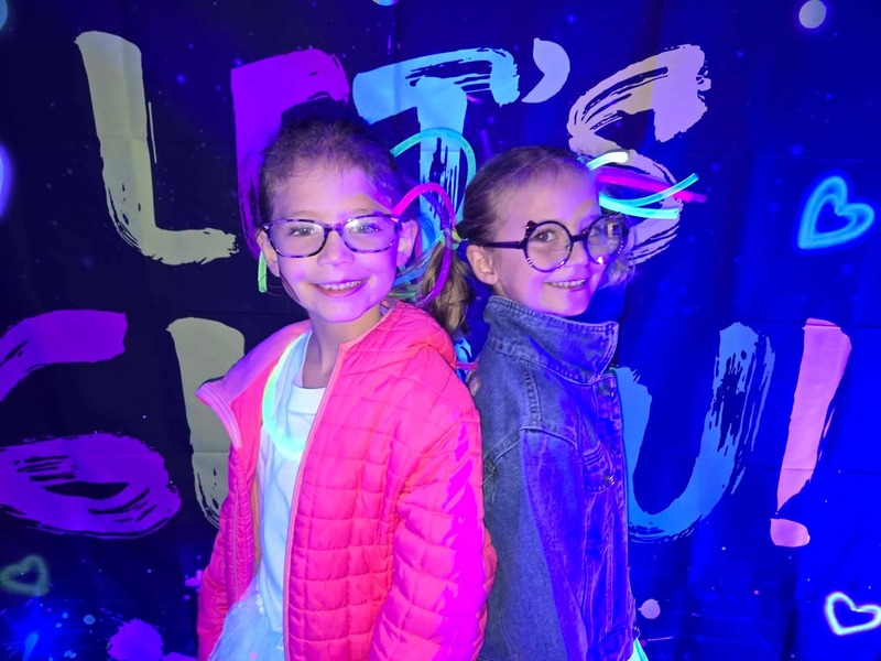 Students in glow party photo booth.